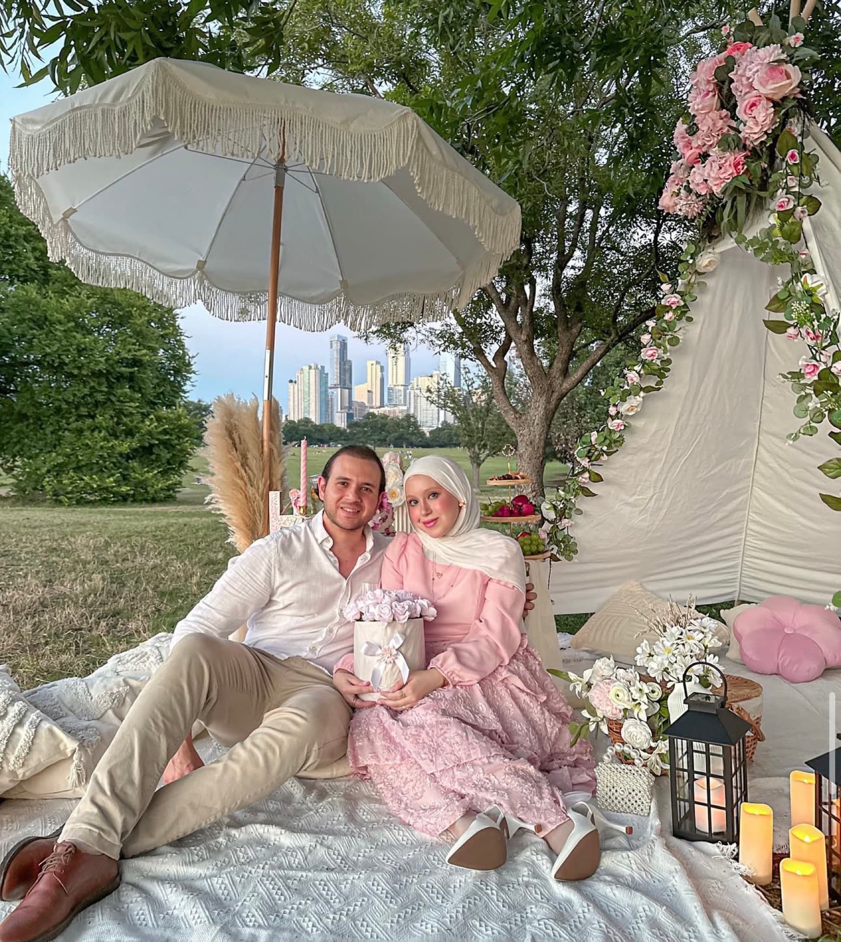 Couple at a romantic lakeside picnic with the Austin skyline behind them