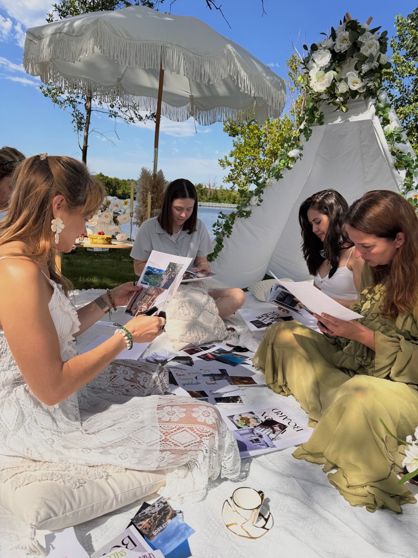 Friends making vision boards at a lakeside picnic in Austin