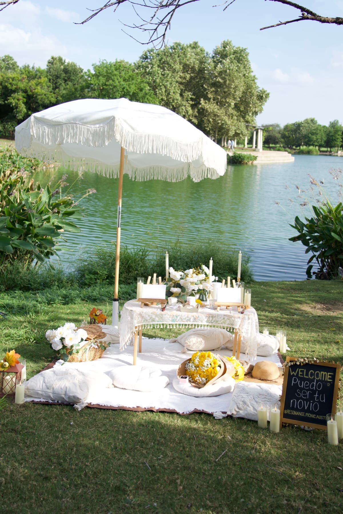 Boho picnic proposal with a yellow rose bouquet by the lake in Austin