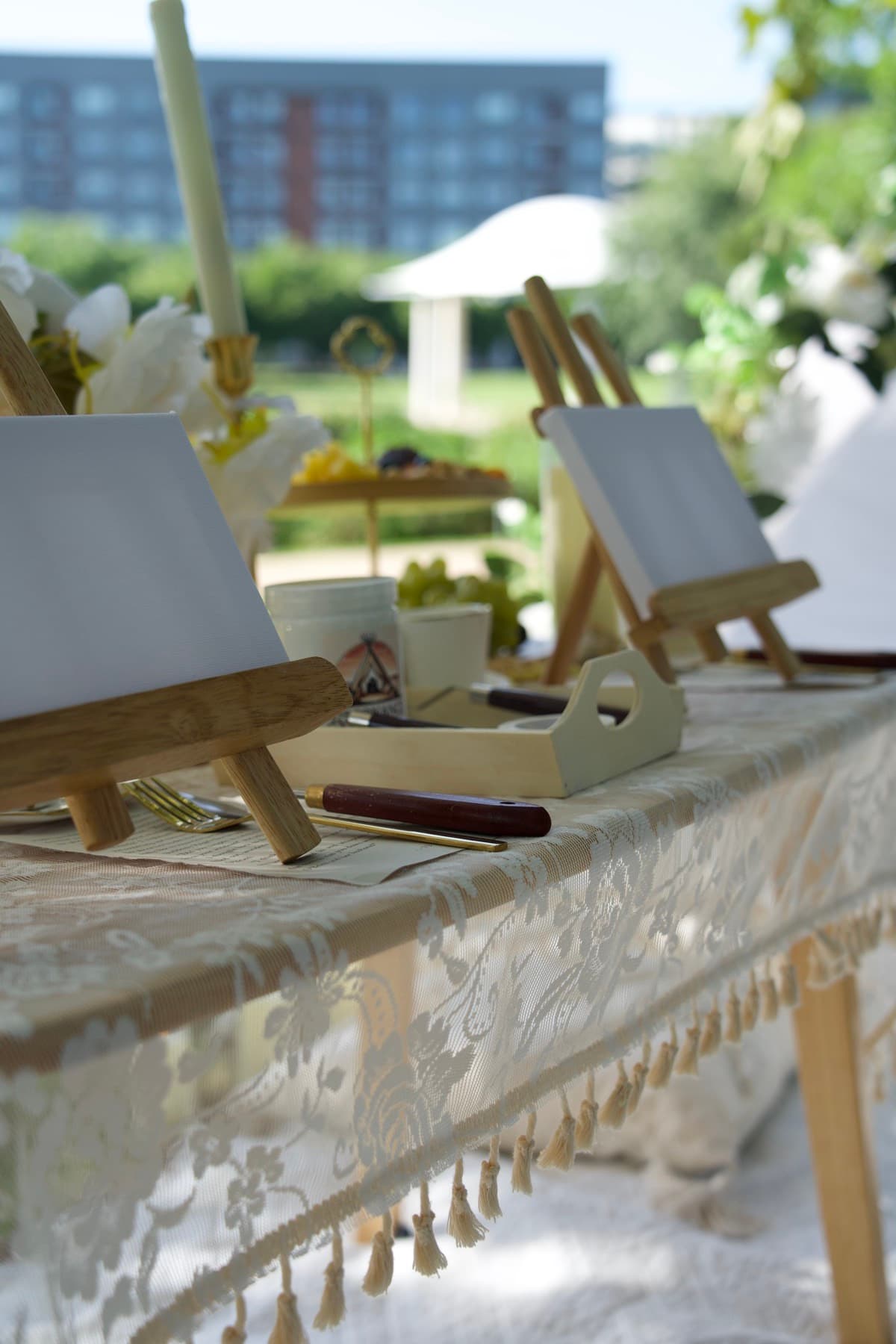 Texture painting setup with mini canvases and easels on a lace picnic table in Austin