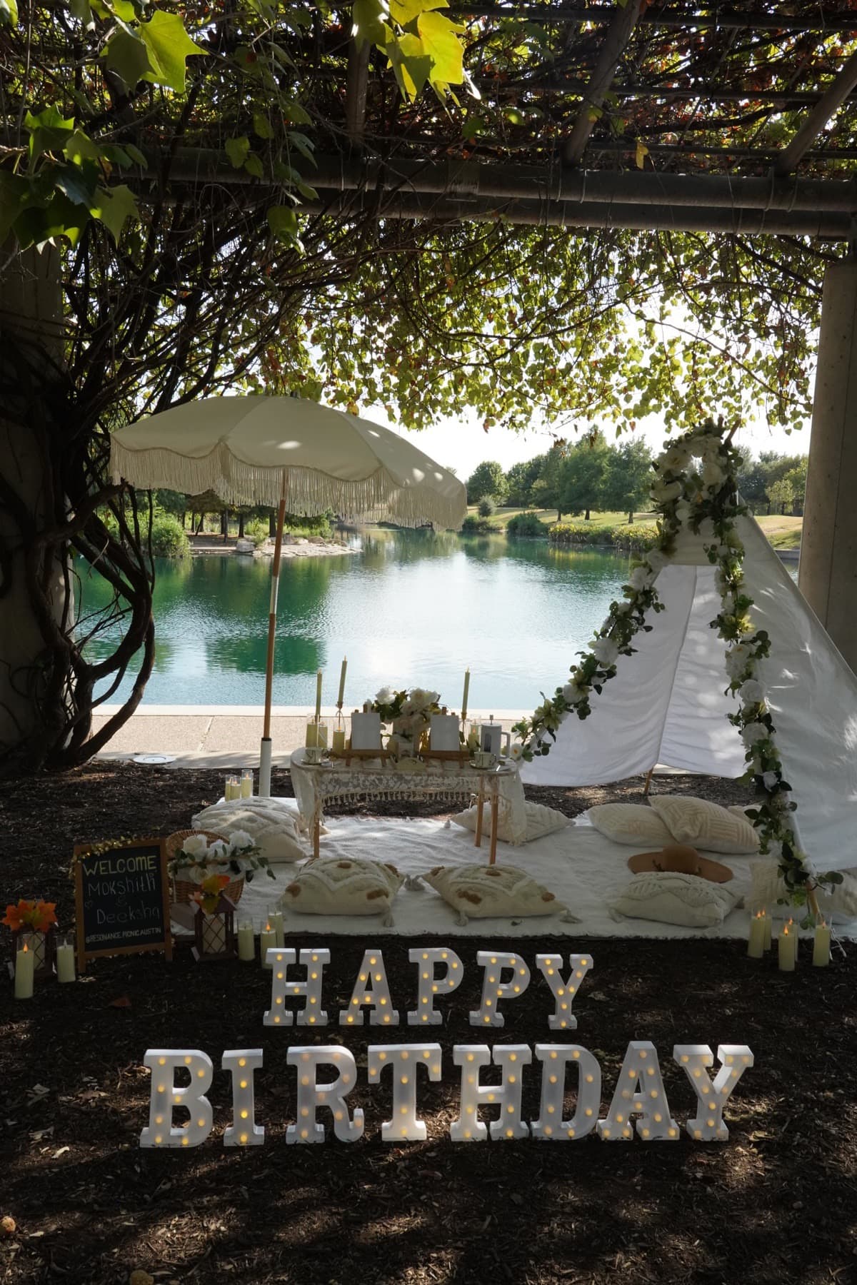 birthday picnic with glowing letters and a lake view in Austin